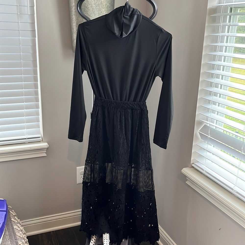 Black turtleneck dress. Size medium. Cute detail at the bottom. Really cute
